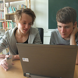 persons in front of laptop