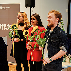 Picture of graduates with sunflowers