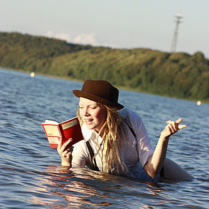 Foto einer lesenden im Wasser der Flensburger Förde liegenden Person