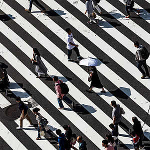 Different people crossing a street